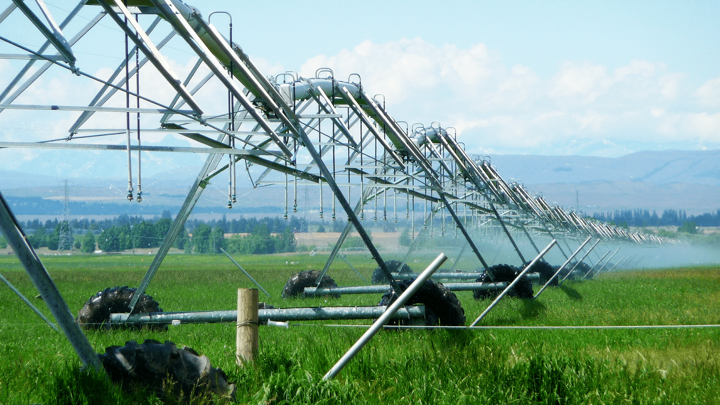 An irrigation system spraying water in a pasture