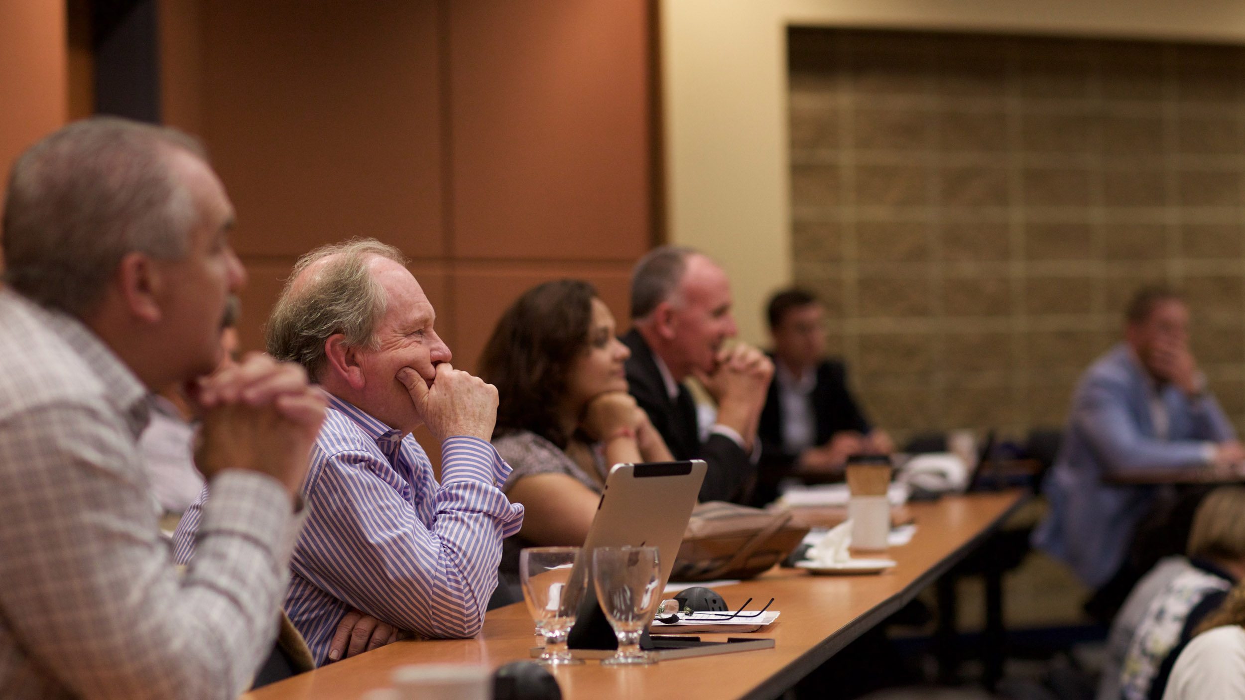 Men and women in a classroom listening to a presenter