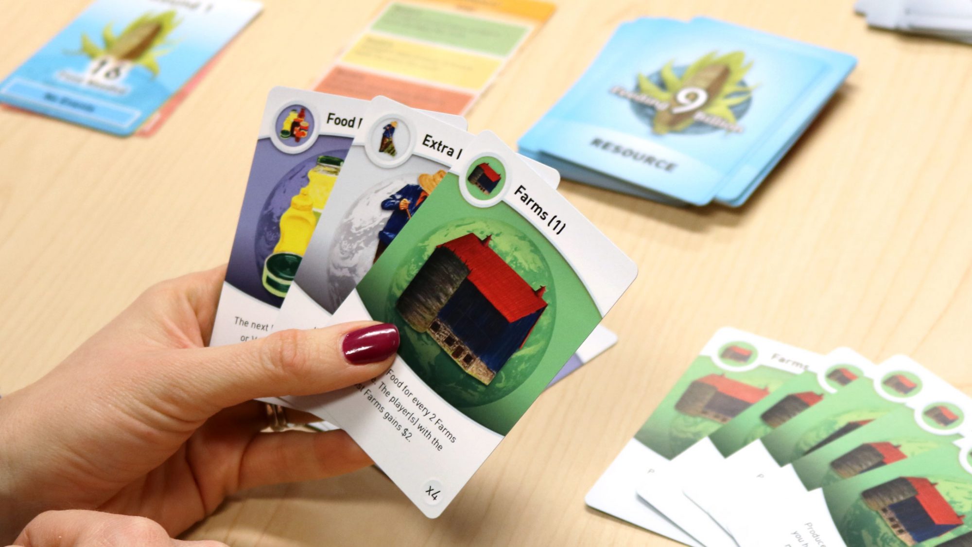Hand holding Feeding 9 Billion Cards