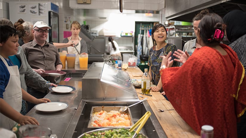 Community gathered in a kitchen.