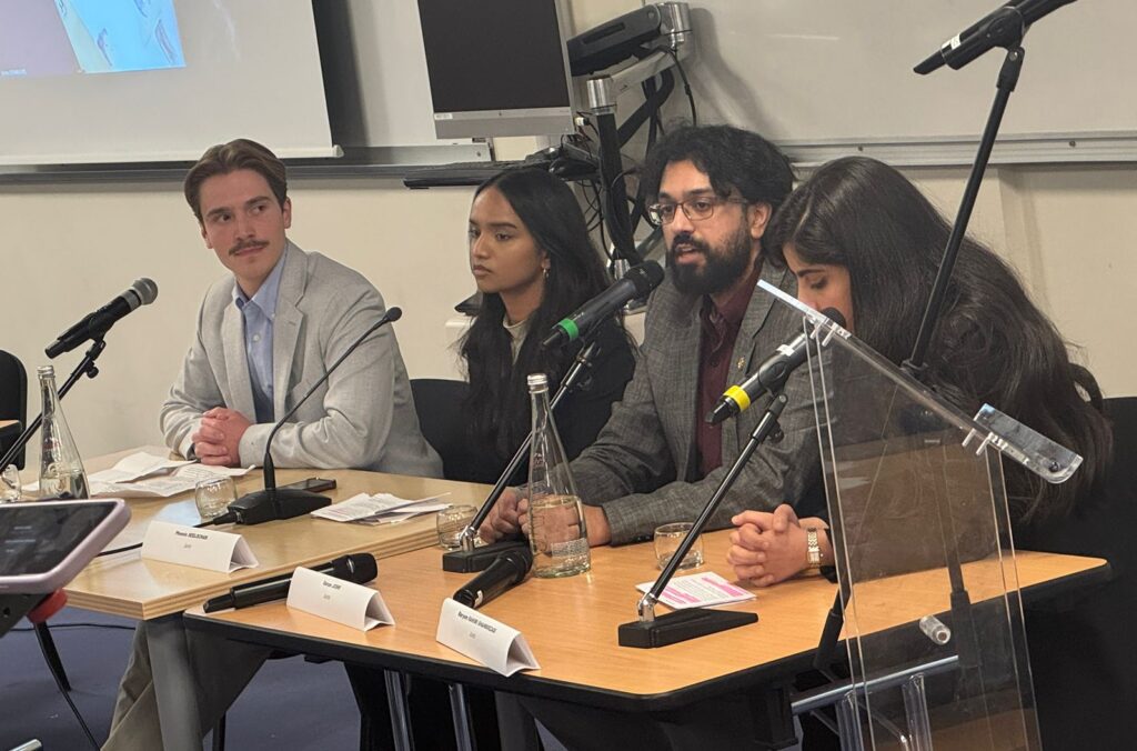 Varun Joshi speaks in a seated panel