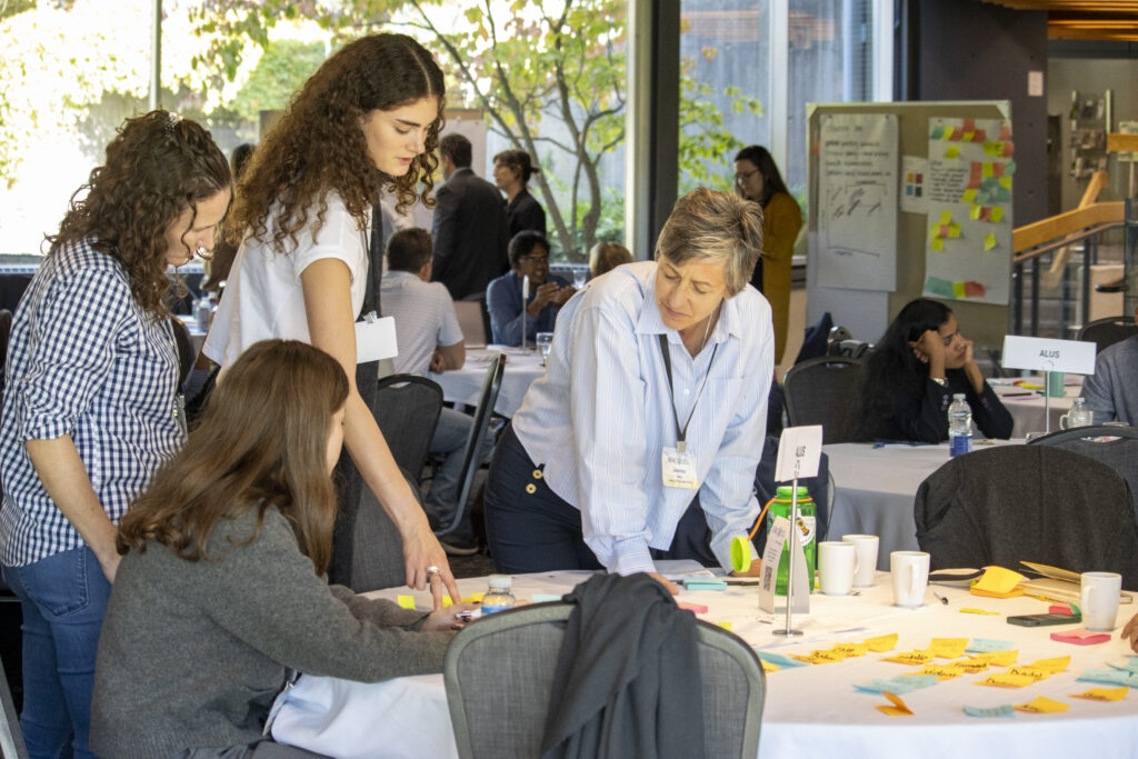 Students collaborate with mentor Jeanna Rex, Education Lead at Arrell Food Institute, at the ALUS challenge table during the Innoveat Ontario hackathon, brainstorming biodiversity outcomes through the CARE experiential learning program.